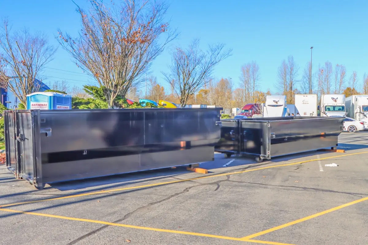 Professional dumpster rental service with roll-off container on residential driveway in Haiku-Pauwela